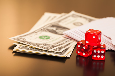 set of playing card with dices and money on reflective tableの写真素材