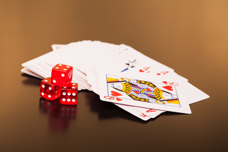set of playing card with dices on reflective table