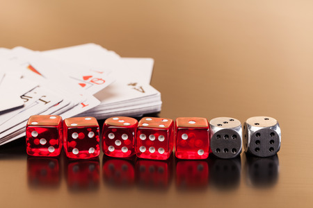 set of playing card with dices on reflective table