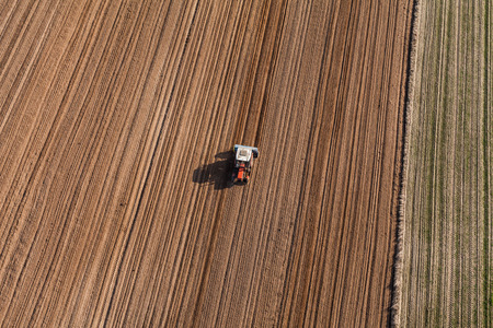 aerial view of the tractor working on the harvest field  in Polandの写真素材