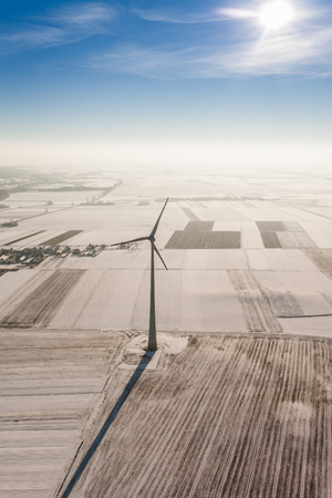 aerial view of wind turbine on a winter field in Polandの写真素材