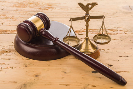 Law theme, mallet of judge, wooden gavel on wooden backgroundの写真素材