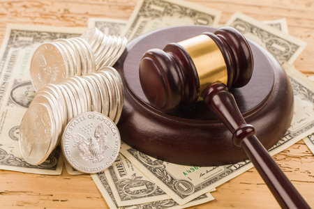 Wooden judge gavel and money on a wooden table, law conceptの写真素材