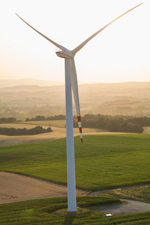 An image of windturbine generator in the countryside at sunset