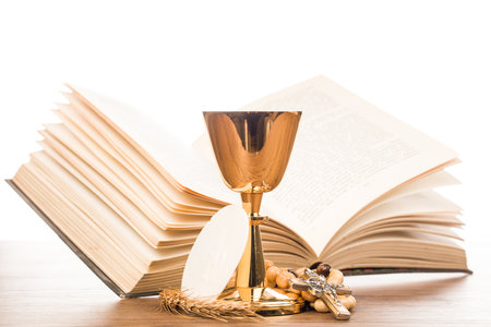 Holy communion concept with chalice and bible isolated on white backgroundの写真素材