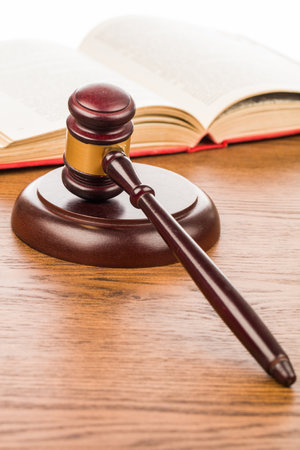 Wooden judge gavel and book on wooden table, law conceptの写真素材