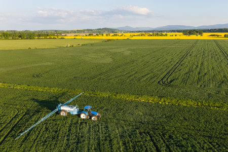 aerial view of the tractor on the harvest fields near Nysa city in Polandの写真素材