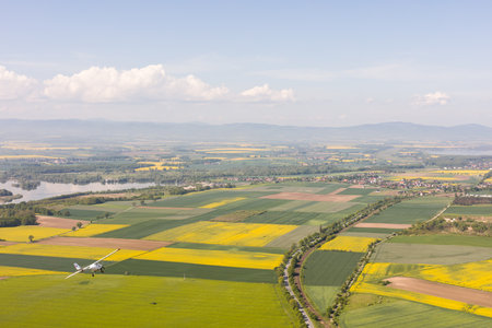 aerial view of the harvest fields and aircraft  flying near Nysa city in Polandの写真素材