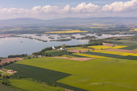 aerial view of the harvest fields and aircraft  flying near Nysa city in Polandの写真素材