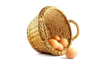 few eggs in a basket on the white backgroundの写真素材