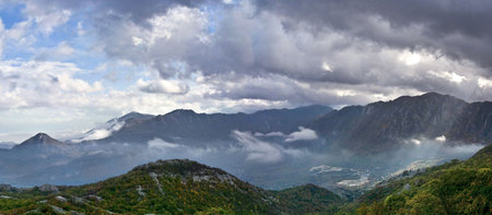 panoramic view of autumn in mountains with dramatic skyの写真素材
