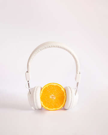 orange with white headphones.modern visual aesthetic ideaの写真素材