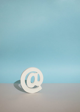 at sign or symbol on a blue grey background.minimal art concept with space
