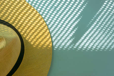 tropic summer beige hat on a blue background with interesting shadows.summer aesthetic ideaの写真素材