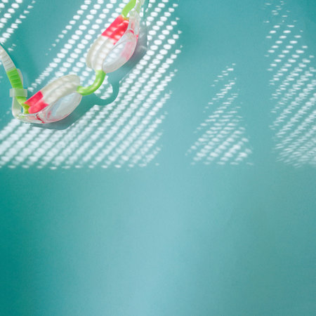 swimming goggles on interesting blue background with shadows.summer sports swimming ideaの写真素材