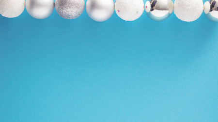 snowy white and metallic silver baubles in a row waiting for Christmas holidays.Preparations festive advent conceptの写真素材