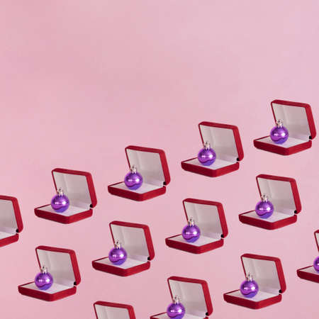 silver metallic shiny bauble coming out of jewellery box.Christmas winter holidays aesthetic design on a pink backgroundの写真素材