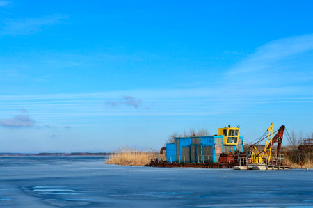 Landscape with a barge by the shore in winter at the Voronezh reservoir. Voronezh, Russia. 2015.の写真素材