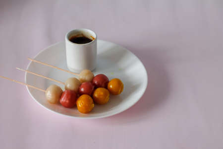 japanese dango treat on white plate and pink backgroundの写真素材
