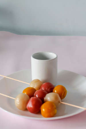 japanese dango treat on white plate and pink backgroundの写真素材