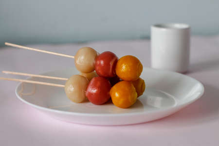 japanese dango treat on white plate and pink backgroundの写真素材