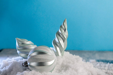 a christmas gift in a red box with a green one lies on the table, the girl stretches out her hand with a bank card. buying a gift online for christmasの写真素材