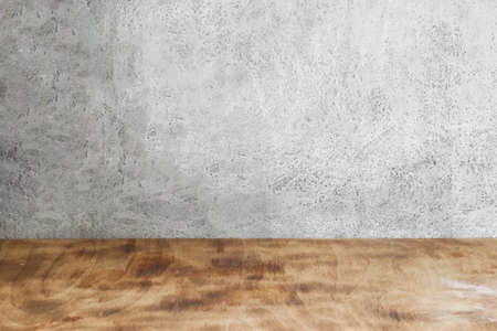 empty background, gray textured wall under concrete and wooden brown table with traces of flourの写真素材