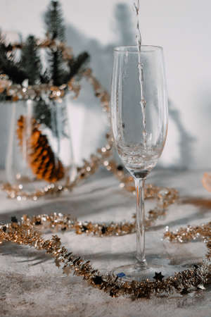 a glass of champagne, tangerines, Christmas tree, garlands in the backgroundの写真素材