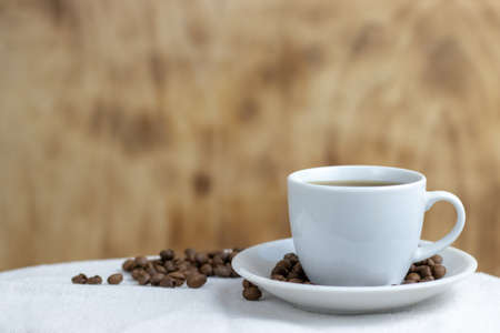 Roasted coffee beans lie in a white linen bagの写真素材