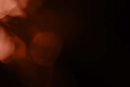 bokeh calming peach light on black background overlayの写真素材