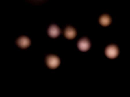 bokeh warm white light on black background overlayの写真素材