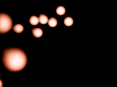 bokeh calming peach light on black background overlayの写真素材