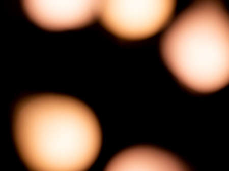 bokeh warm white light on black background overlayの写真素材