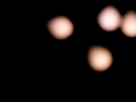 bokeh warm white light on black background overlayの写真素材
