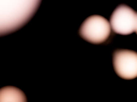 bokeh warm light on black background overlayの写真素材
