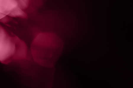 bokeh gentle pink light on black background overlayの写真素材