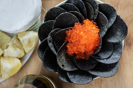 Black chips with caviar, salted lemon, ham, blue cheeseの写真素材