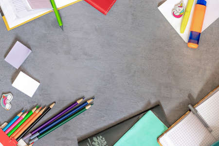notebooks, school and office supplies lie on a gray backgroundの写真素材