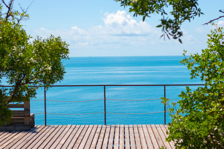 view of the blue sea from the wooden veranda