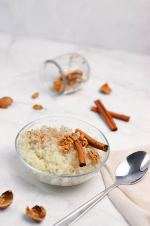 Rice porridge with cinnamon and walnut. White backgroundの写真素材
