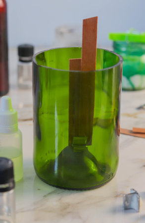 a candle made of soy wax with a trimmed wine bottle. Manufacturing Processの写真素材