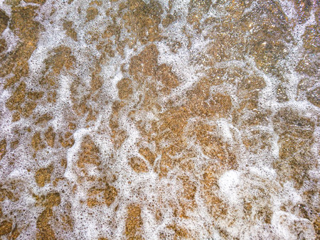 Sea foam on the sand. Top viewの写真素材