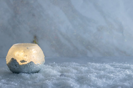 A lamp with an icy decor lies in the snow. Christmas backgroundの写真素材