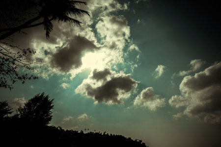 Beautiful sunset at tropical beach with palm trees. Ocean landscape in vintage style. Thailand