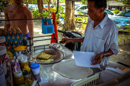 Thai cooks traditional pancake with bananaのeditorial素材