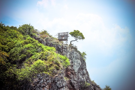 Hut on a limestone cliff in the Andaman Seaの写真素材