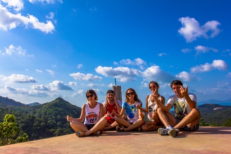 Happy friends on the mountain and beauty landscapeの写真素材