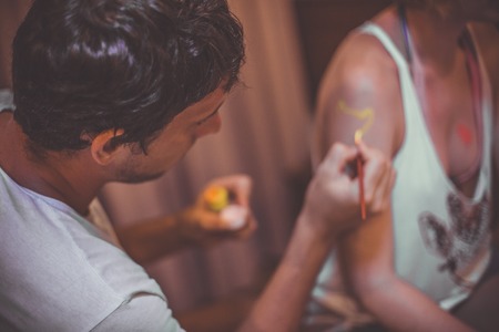 Friends are painted and ready to party.の写真素材