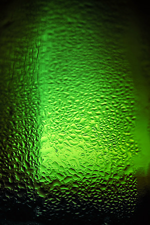 Water drops texture on the green bottleの写真素材