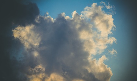 Blue sky with clouds in retro styleの写真素材